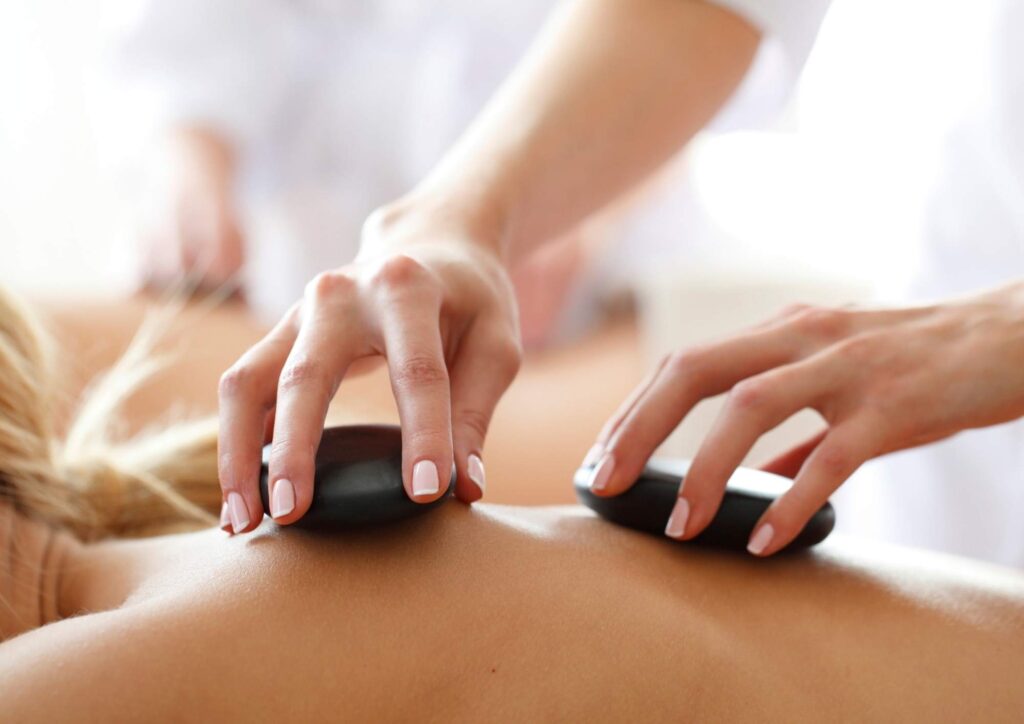 Therapist performing professional massage therapy treatment on client